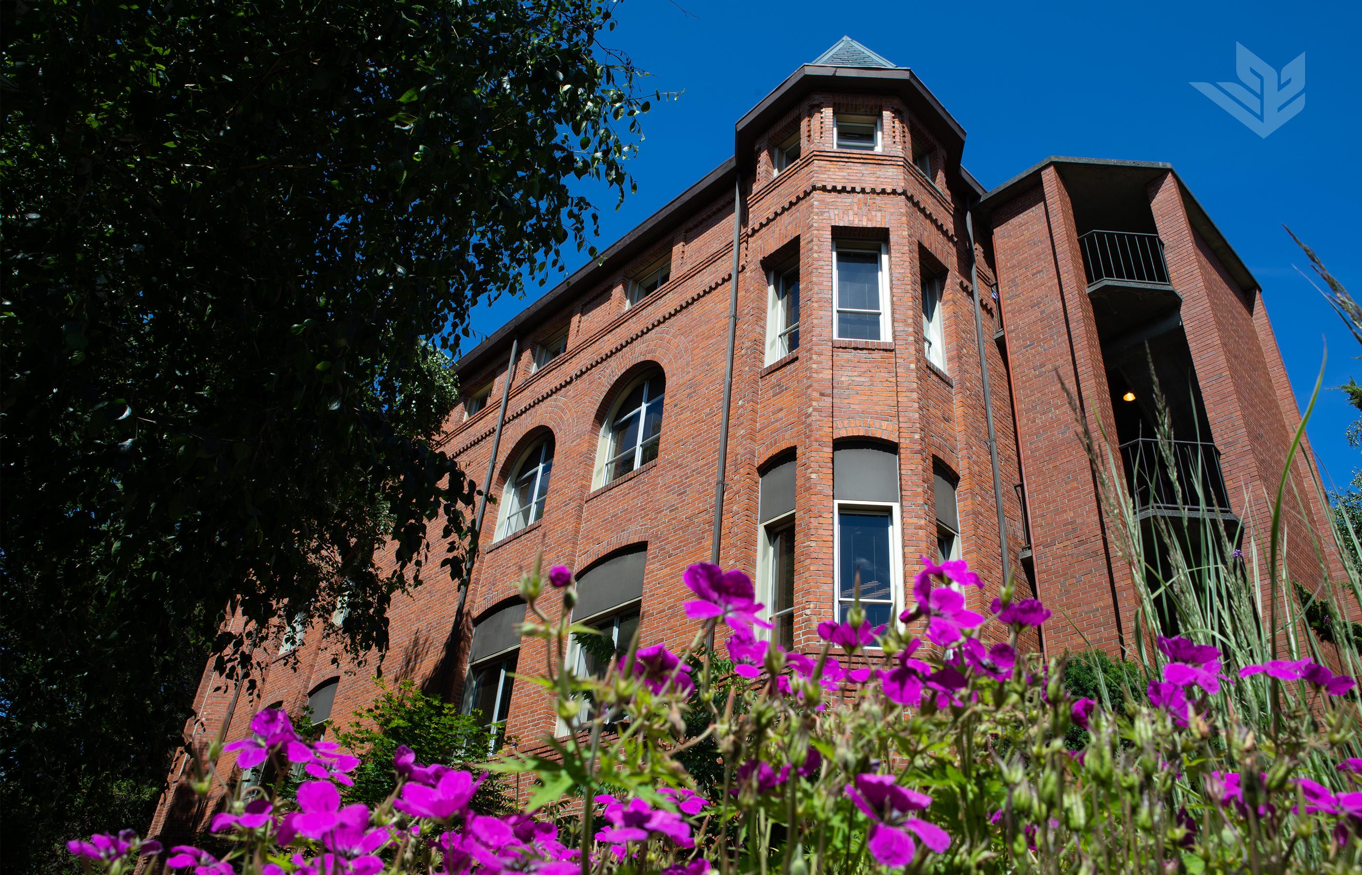 A summertime image of historic Alexander and Adelaide Hall on the Seattle Pacific University campus.